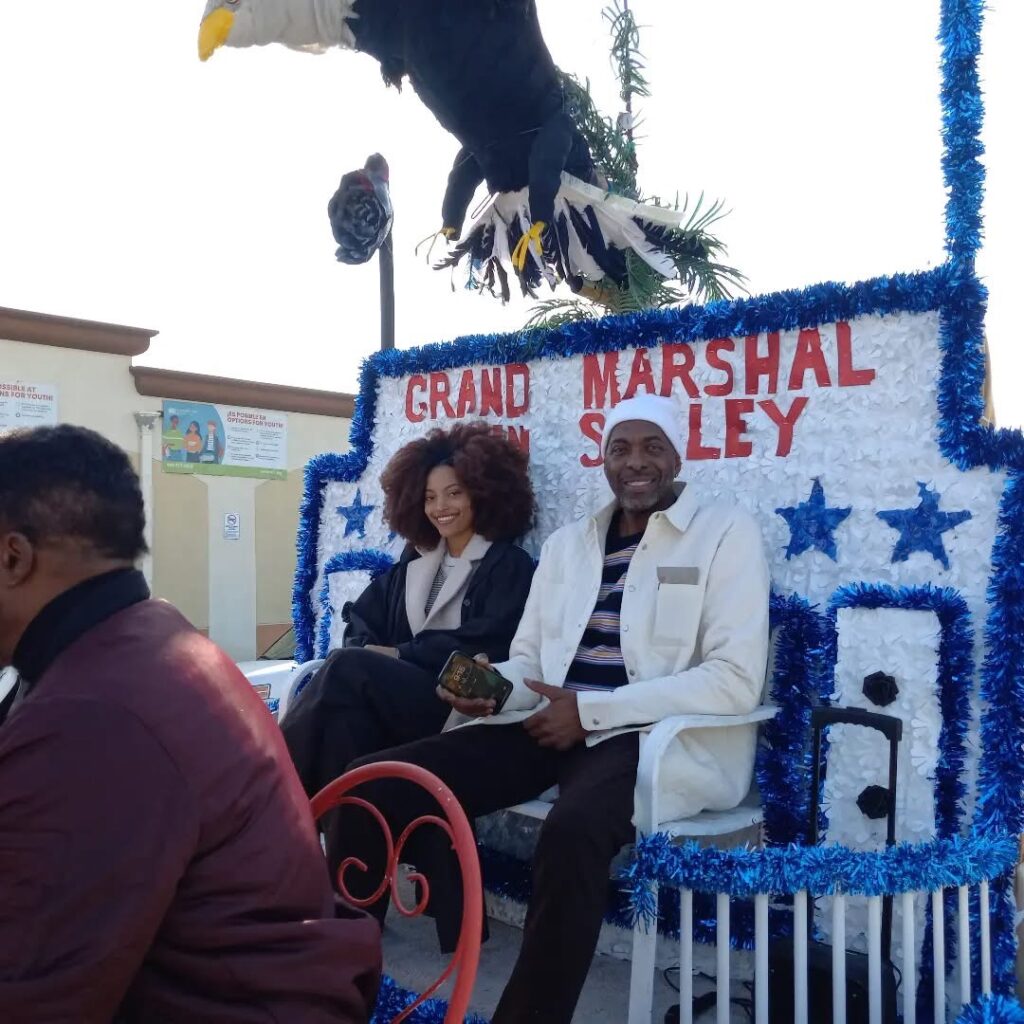 Black History Parade Grand Marshal John Salley and his daughter. 