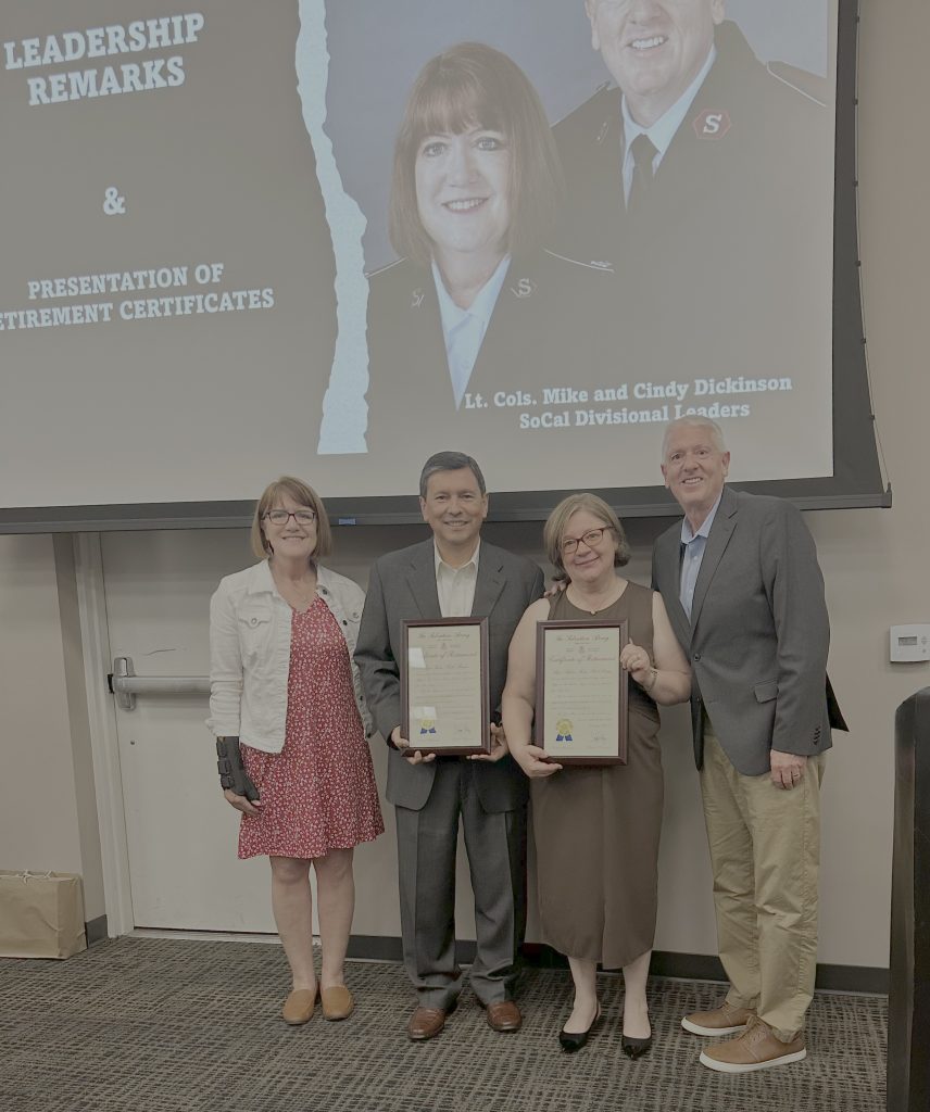 Photo Caption: Majors Isias and Almeda Braga retire and are presented certificates of service by The Salvation Army Divisional Commanders, Colonels Mike and Cindy Dickinson.
