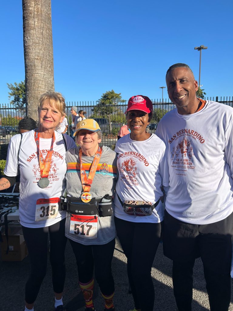 Turkey Trot winners, participants with Felecia and Damon Alexander, visited the Salvation Army Homeless Shelter on Christmas Eve, where they handed out toys to children and celebrated with families in need.